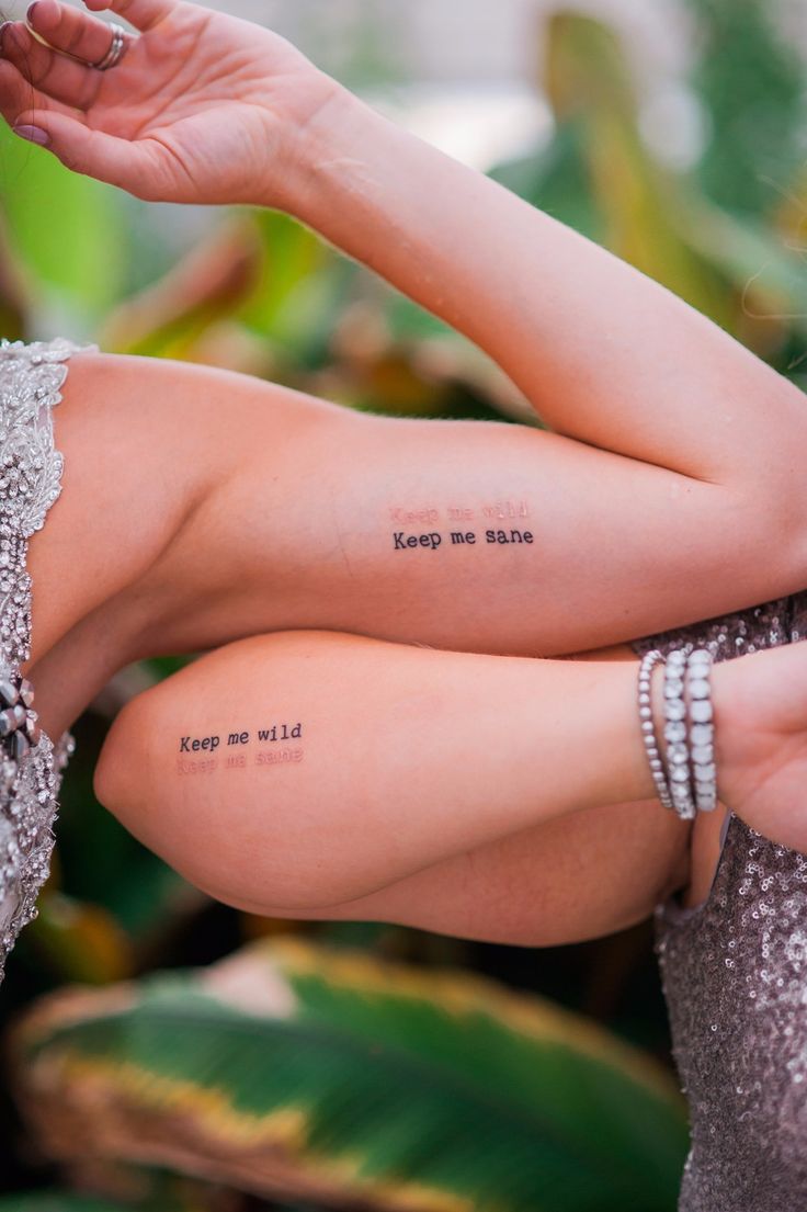 a woman with her arm wrapped around the back of her body and writing on it