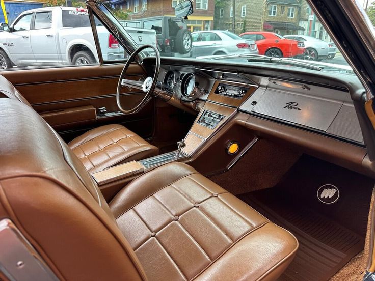 the interior of an old car with brown leather seats