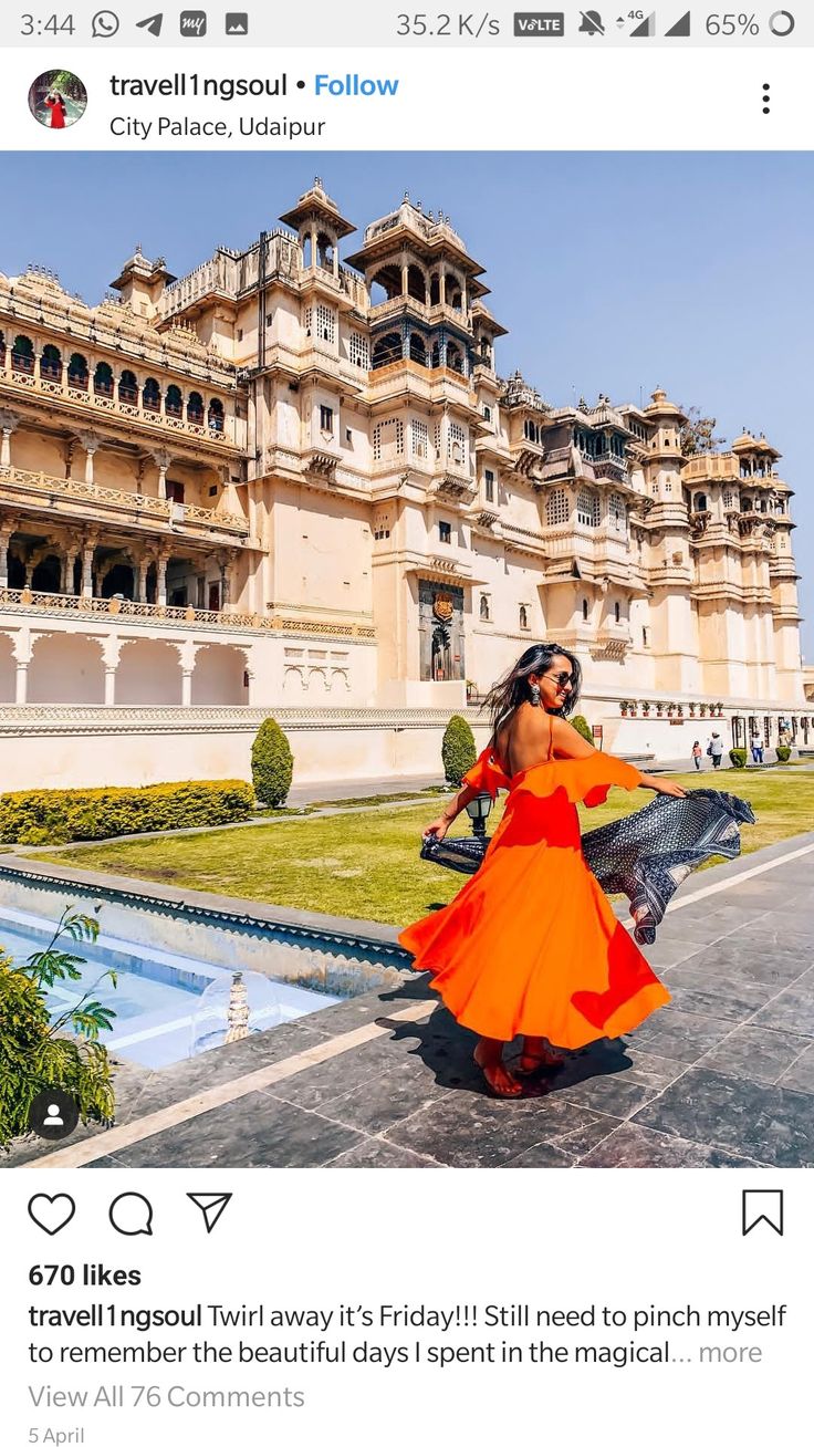 a woman in an orange dress is standing outside