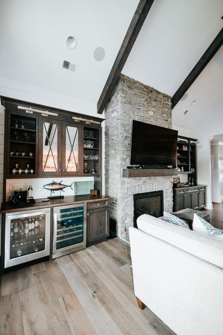 a living room filled with furniture and a fire place in the middle of a kitchen