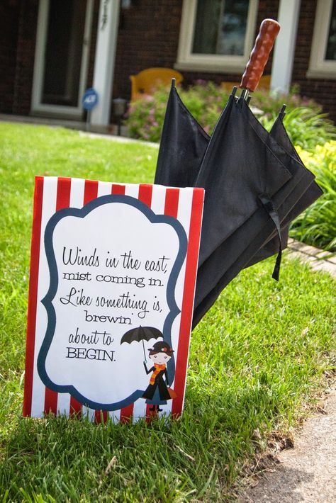 an umbrella and sign sitting in the grass