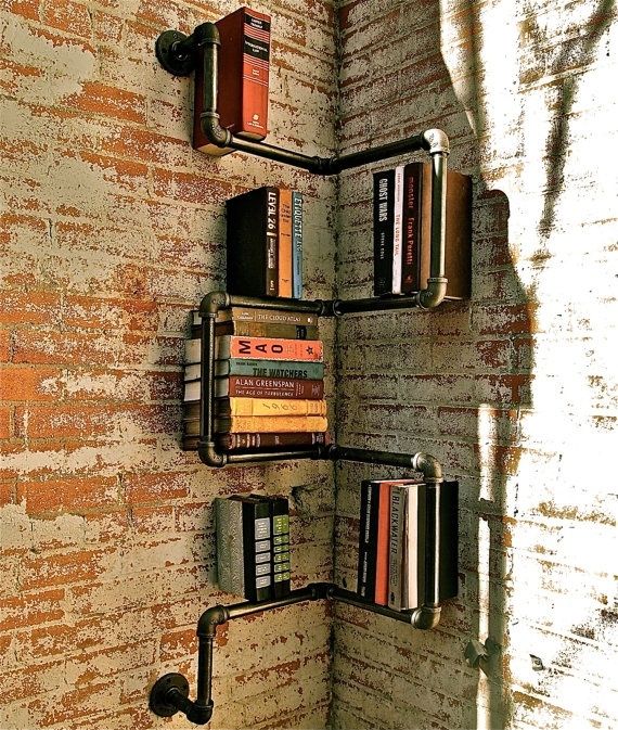 there is a book shelf on the brick wall