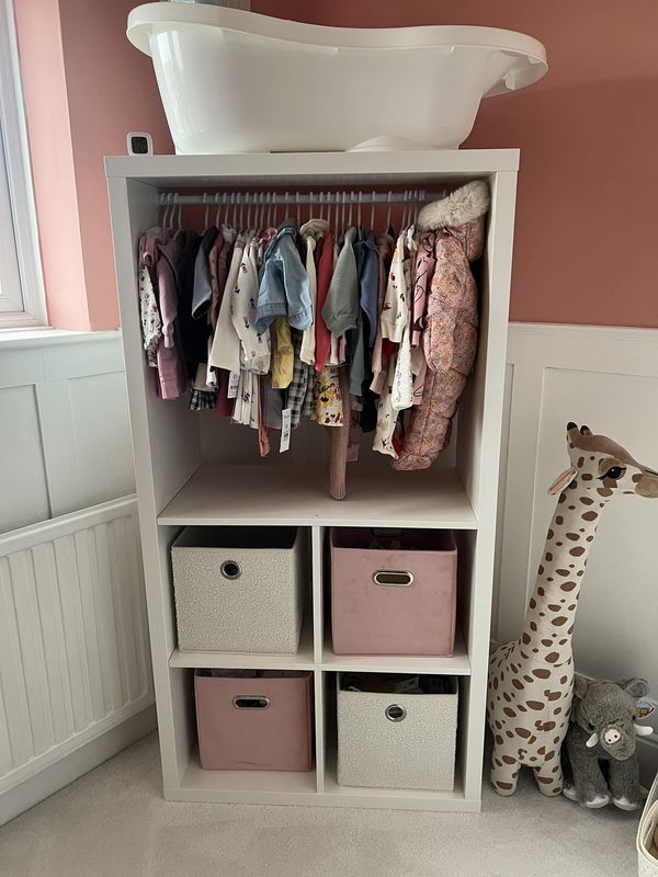 a baby's closet with clothes and toys in it