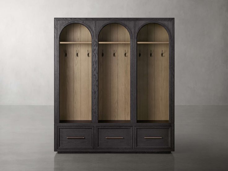 an open bookcase with three doors and two drawers on each side, in front of a gray wall