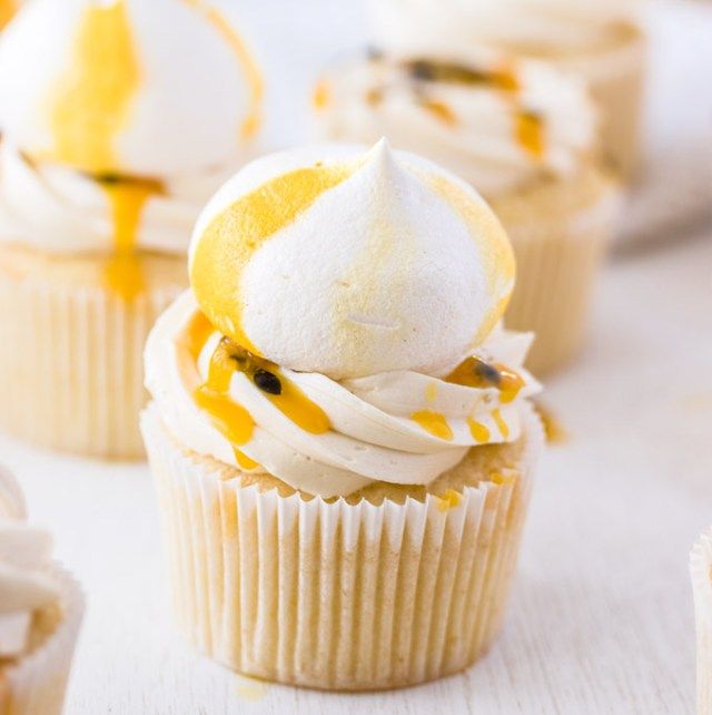 cupcakes with white frosting and yellow decorations