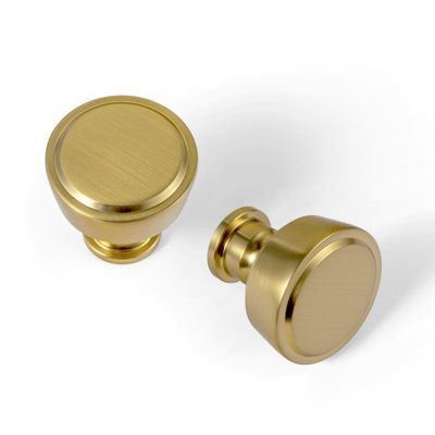 two brass knobs on white background