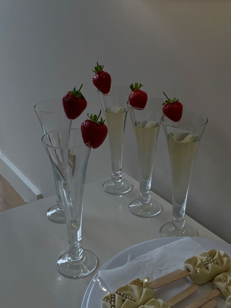 strawberries and champagne are on the table ready to be served