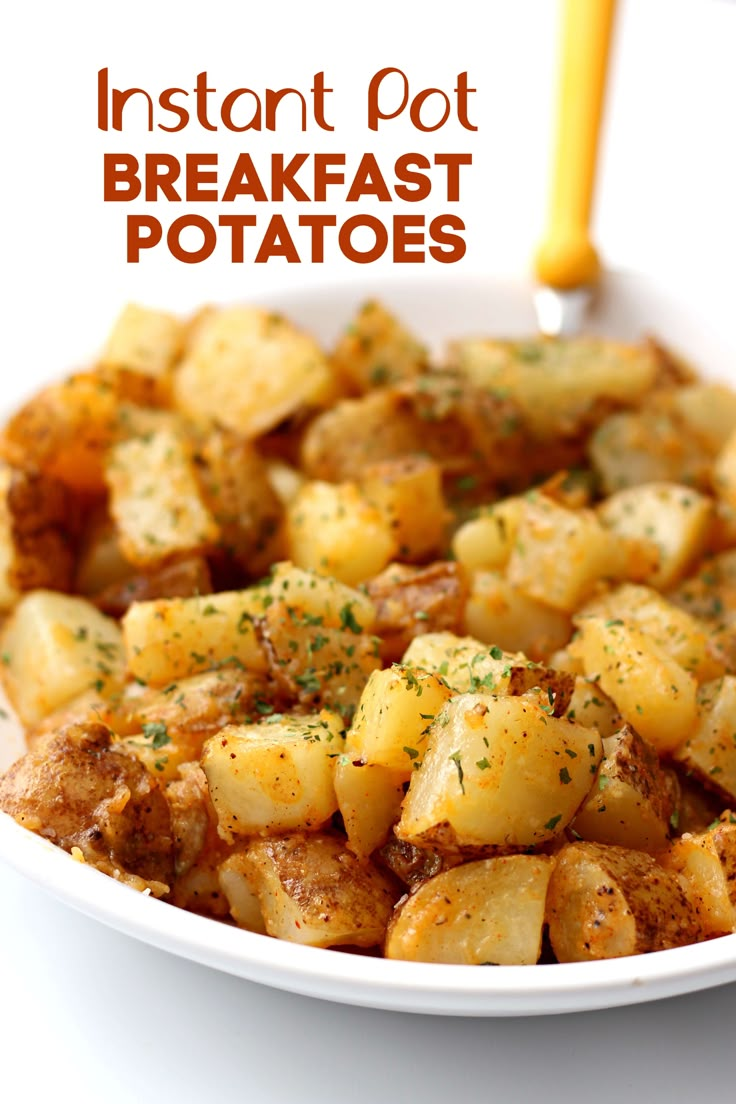 a white bowl filled with potatoes covered in seasoning next to a yellow handled fork