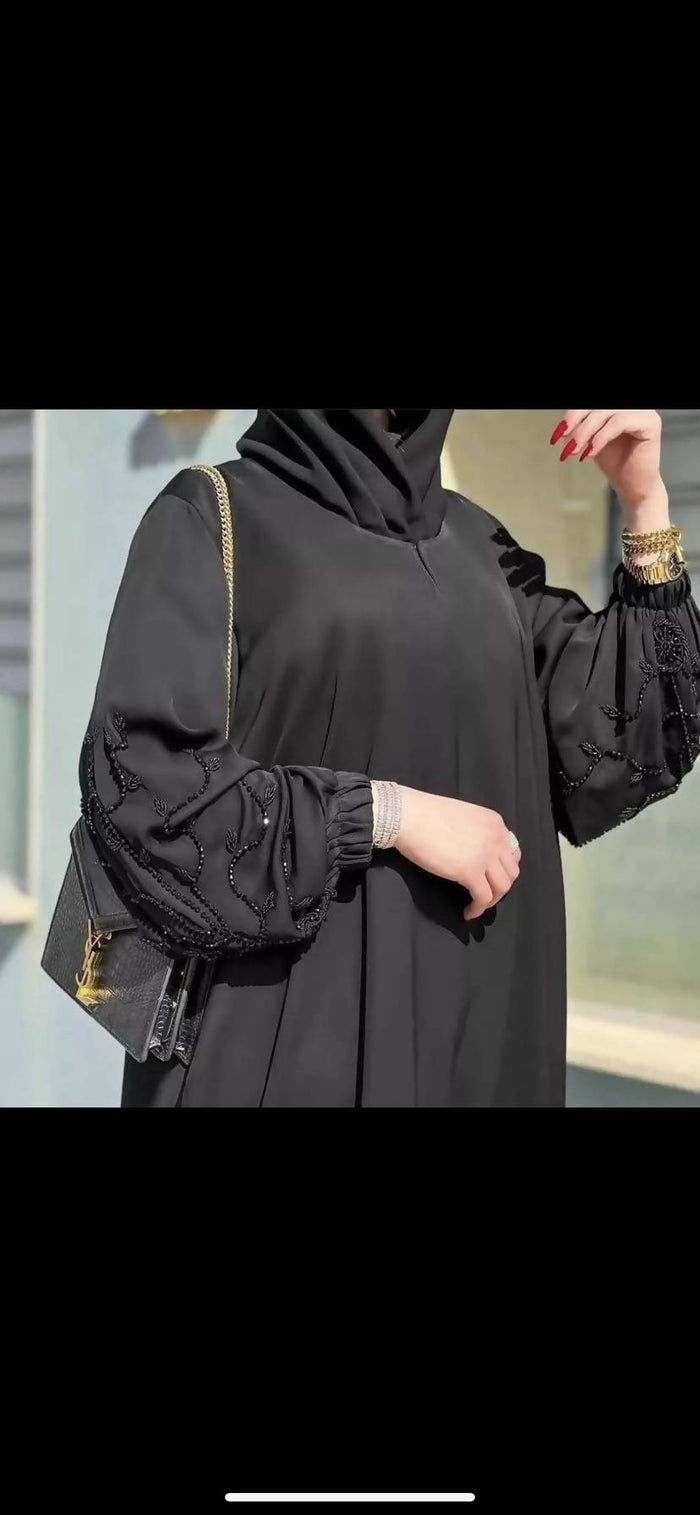 Discover elegance with our stunning black nidha abaya, intricately designed with delicate netted flowers. This piece combines timeless sophistication with a touch of contemporary charm, perfect for enhancing any wardrobe. Crafted from luxurious, breathable nidha fabric, it ensures both comfort and style. Ideal for spec Black Abaya Aesthetic, Dubai Burkha Designs, Abaya Sleeves, Abaya Designs Dubai, Luxury Abaya, Burkha Designs, Elegant Abayas, Abaya Noir, Abaya Designs Latest