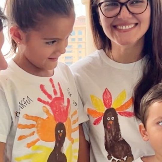 a woman and two children wearing thanksgiving shirts