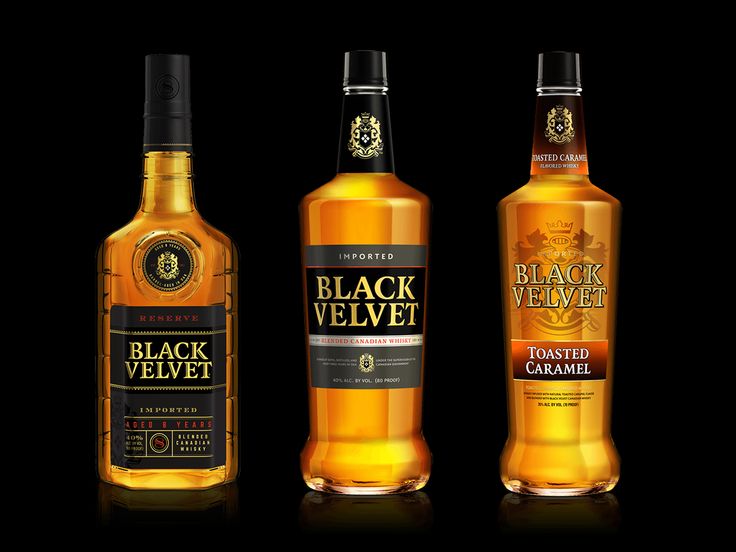 three bottles of black velvet whiskey on a dark background