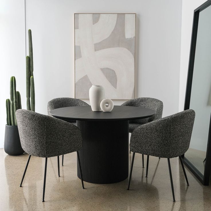 a black table with four chairs around it