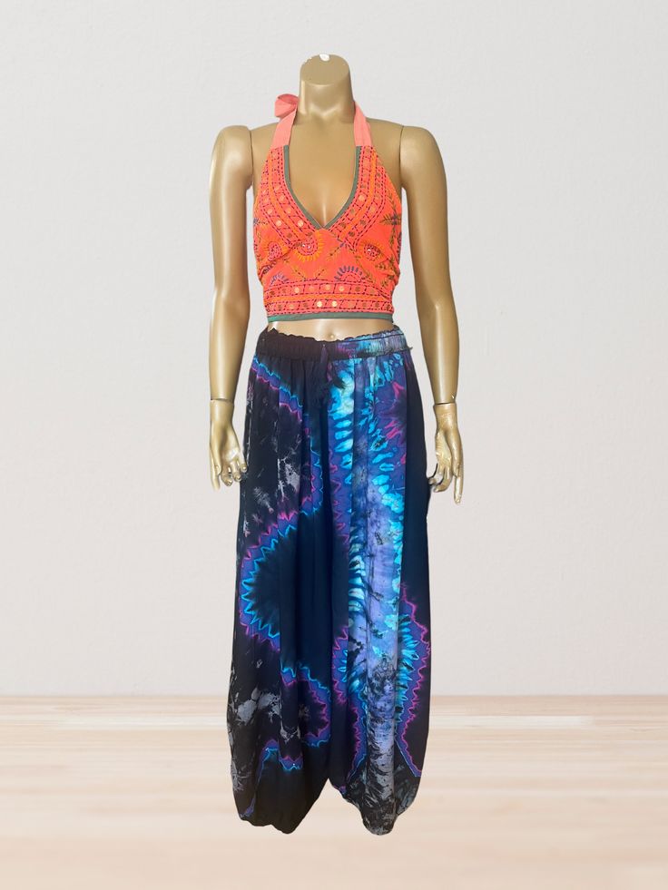 This vibrant, hand-embroidered bikini halter top offers stylish Boho-inspired fashion with its colorful threads and sequin embellishments. Paired with jeans or a skirt, this is the perfect summer top to stand out in and make a statement. The lining is a contrasting color to give it a unique, eye-catching look. One Size Made in India Care Instructions: Dry clean only Girl In The Mirror, Colorful Threads, Inspired Fashion, The Mirror, Summer Top, Bright Orange, Perfect Summer, Halter Top, Contrasting Colors