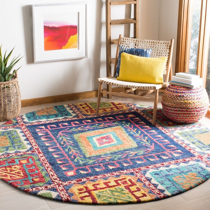 a brightly colored rug in the corner of a room with a wooden chair and potted plant