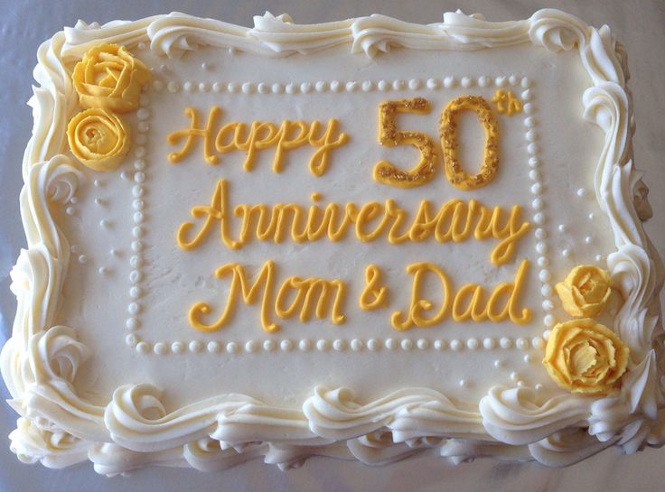 a 50th anniversary cake with yellow frosting and roses on it's side that says, happy 50th anniversary mom & dad