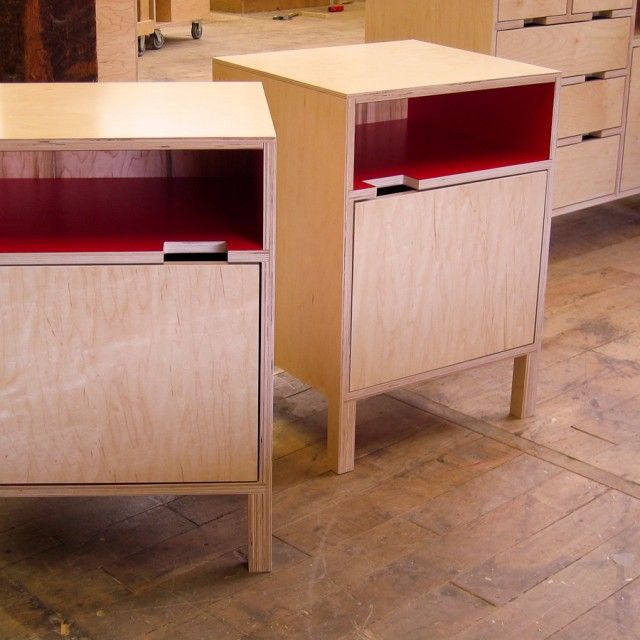 two wooden cabinets sitting next to each other on top of a hard wood floor in a room