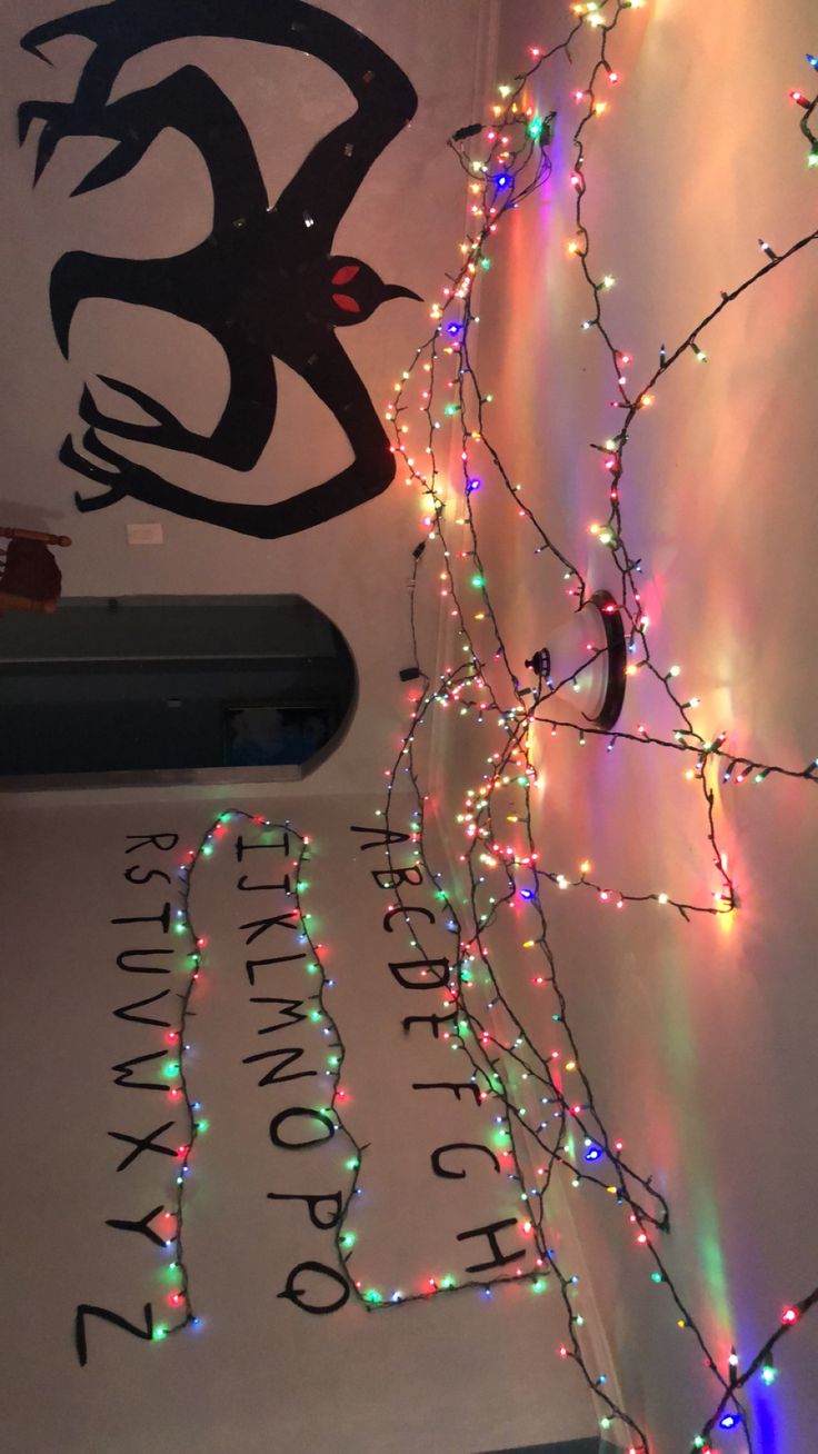 christmas lights are hanging on the wall next to a sign that reads, it's not