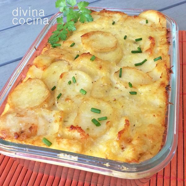 a casserole dish with potatoes and parsley in it on an orange place mat