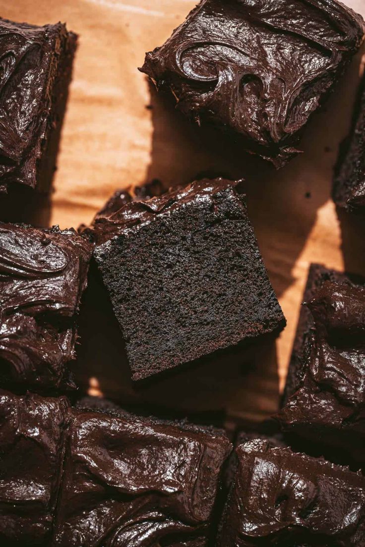 chocolate brownies sitting on top of a wooden table