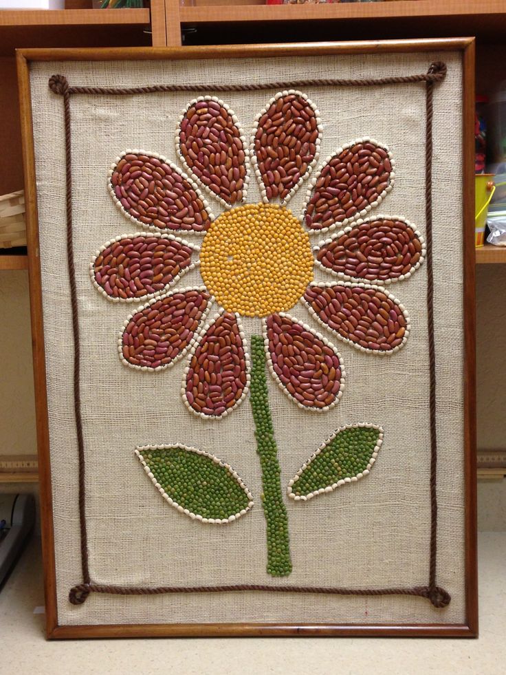 a flower is on display in a wooden frame