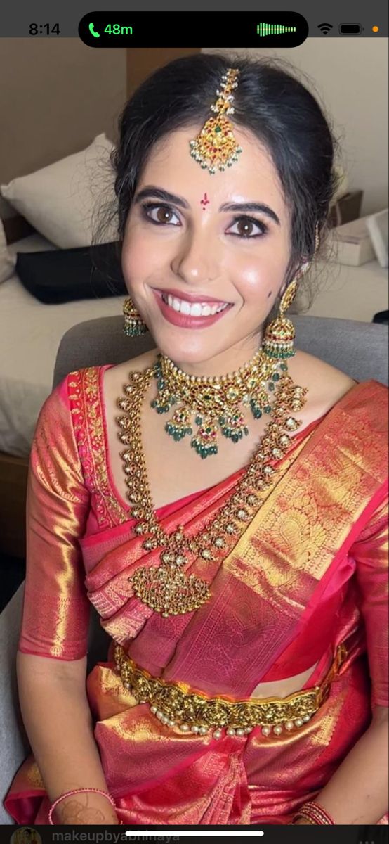 a woman in a red and gold sari