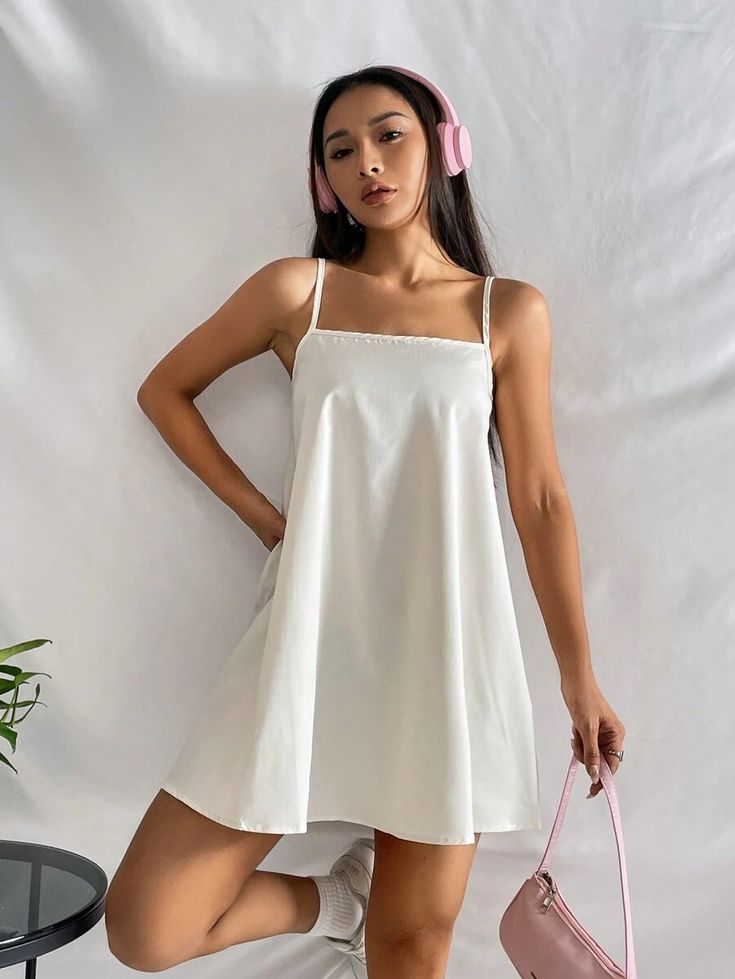 This Barbie Solid Spaghetti Strap Cami Dress is amazingly designed to provide you comfort with style the whole day. This dress blends a casual vibe with a touch of sophistication, making it perfect for any occasion. The plain pattern and sleeveless design exude simplicity, while the flared hem adds a delightful twist. Crafted from premium Polyester fabric, it offers ultimate comfort and a regular fit. Features: Style: Casual Pattern Type: Plain Type: Cami Sleeve Length: Sleeveless Hem Shaped: Fl Casual A-line Suspender Dress For Summer, Summer A-line Suspender Dress For Beach, Casual A-line Mini Dress With Adjustable Straps, White Cami Suspender Dress For Summer, White Cami Suspender Dress With Straps, White Cami Suspender Dress With Adjustable Straps, Brunch Slip Dress With Spaghetti Straps, Trendy Dresses With Adjustable Straps For Brunch, Chic Suspender Dress With Spaghetti Straps For Vacation