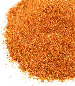 a pile of ground spices on a white background