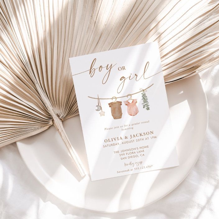 a baby or girl shower card on a plate next to an umbrella and palm leaf