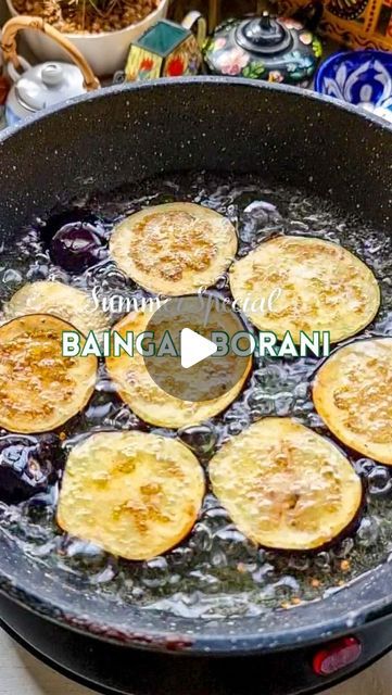 food cooking in a pan on top of a stove with water and other items around it