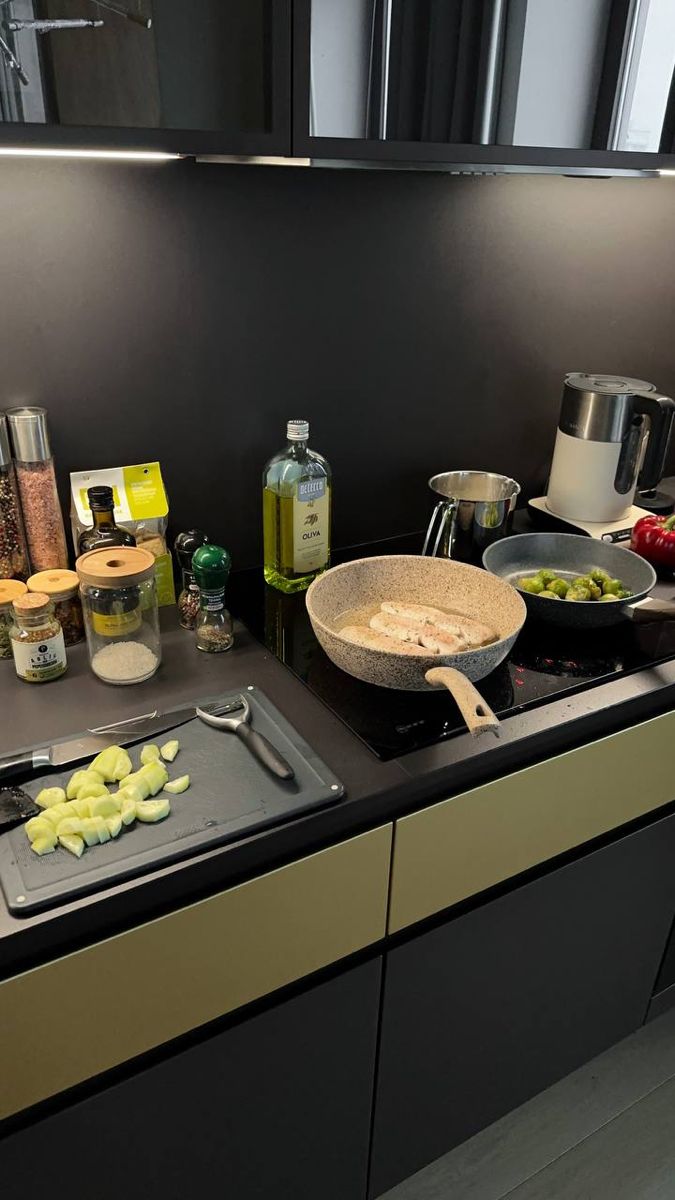 a kitchen counter with food on it and cooking utensils next to the stove