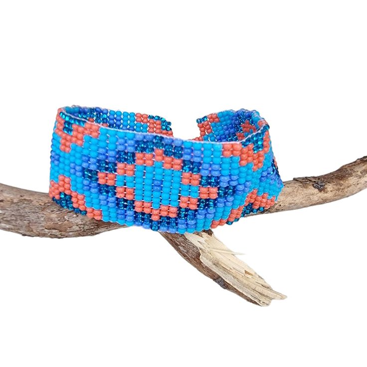 Lovely handmade Huichol beaded bracelet, southwest style,  tribal symbol pattern, light blue, lavender, orange and glitter blue colour, from our Fair Trade partners in Mexico.  Size is approx. between 18.5long cm by 2.5 cm wide. Please also visit my new shop, BALI COCONUT BY ROSA made in Fairtrade partnership with fine Balinese artisans and featuring all natural jewellery: https://www.etsy.com/uk/shop/BaliCoconutbyRosa Spend over $35 US Dollars with us and receive FREE postage for orders to the Artisan Beaded Turquoise Friendship Bracelets, Bohemian Adjustable Cuff Bracelet With Large Beads, Bohemian Cuff Bracelet With Large Beads, Bohemian Blue Hand-strung Bracelets, Adjustable Bohemian Cuff Bracelet With Large Beads, Bohemian Blue Bracelets With Colorful Beads, Blue Bohemian Bracelets With Colorful Beads, Blue Hand-strung Beaded Bracelets For Festival, Southwestern Style Multicolor Handwoven Beaded Bracelets