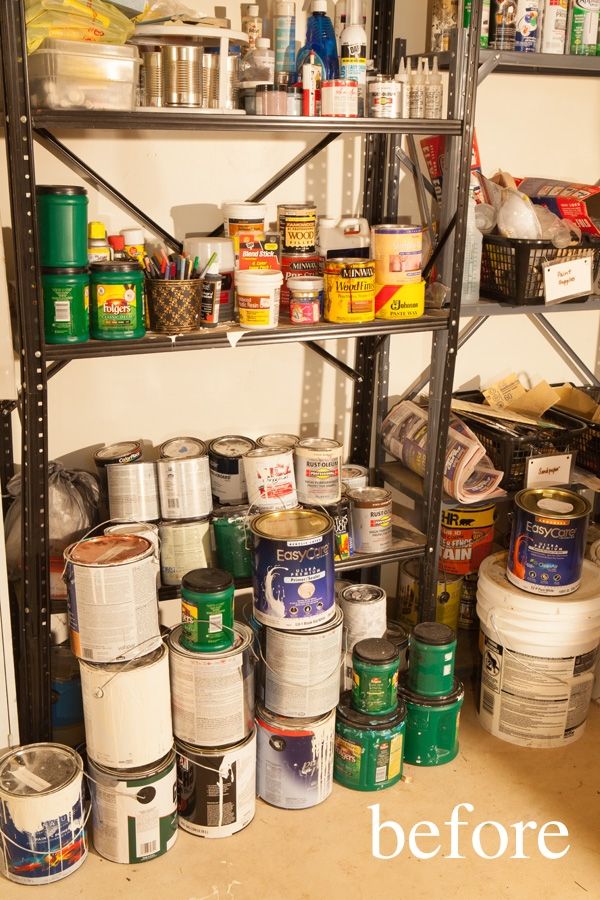 the shelves are full of cans and cans of paint, including one that is empty