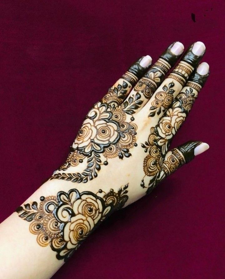 a woman's hand with henna on it