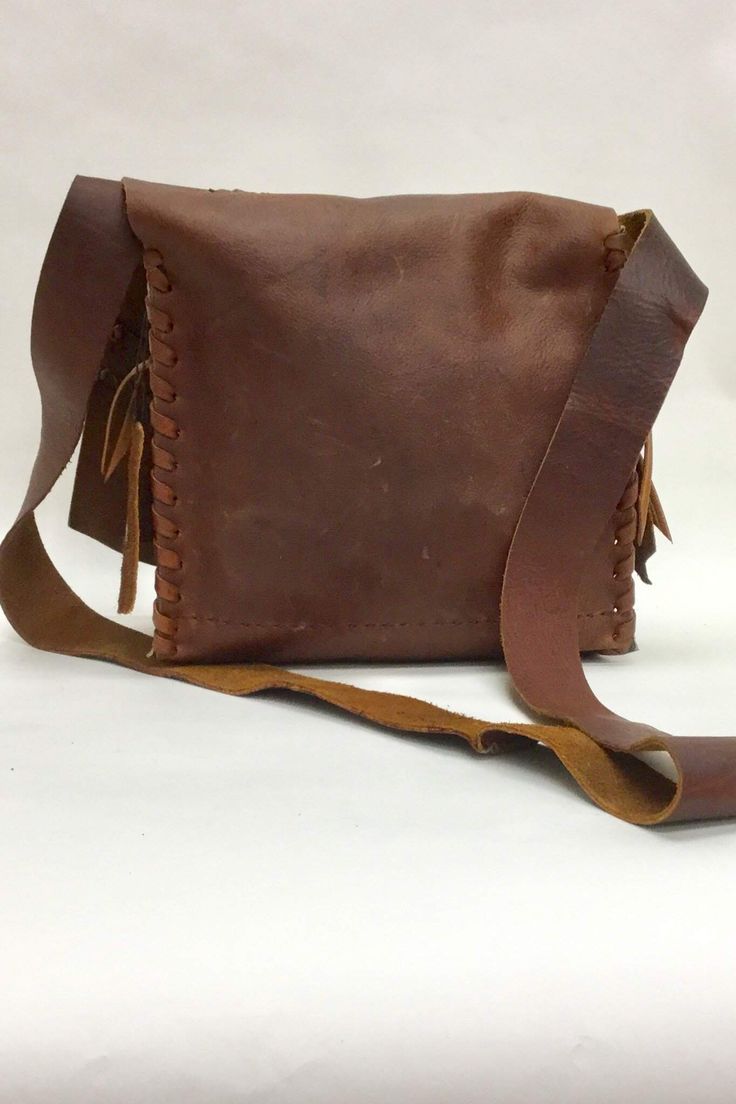 Steel Pony Oil Tan Flap Bag Vegetable Tanned Leather Rectangular Shoulder Bag For Everyday Carry, Rugged Brown Soft Leather Bag, Brown Leather Saddle Bag With Leather Lining, Vintage Brown Rectangular Leather Backpack, Vintage Brown Leather Rectangular Backpack, Leather Hand Tooled Saddle Bag For Daily Use, Brown Leather Hand Tooled Shoulder Bag, Brown Leather Saddle Bag With Flap, Hand Tooled Leather Crossbody Shoulder Bag