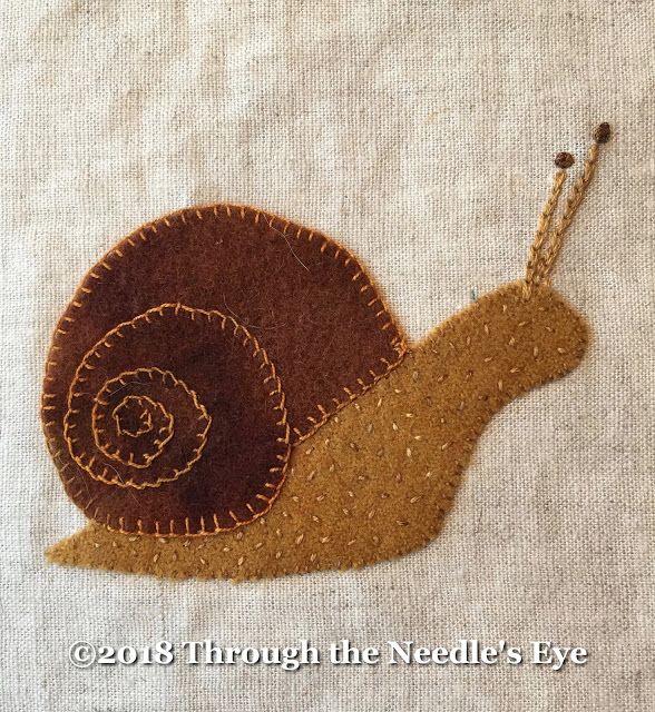 a close up of a snail on a piece of fabric