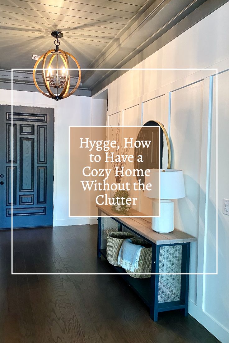 a blue entryway with the words hygge, how to have a cozy home without the clutter