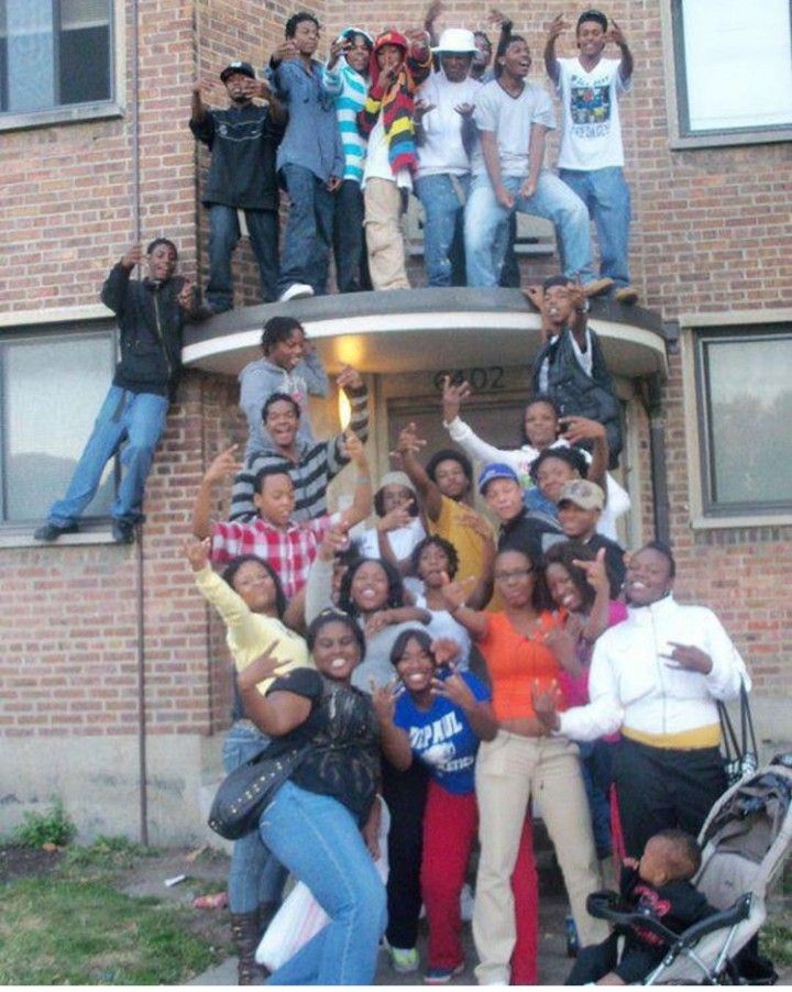 a group of people standing in front of a building with the caption when your family is all hood