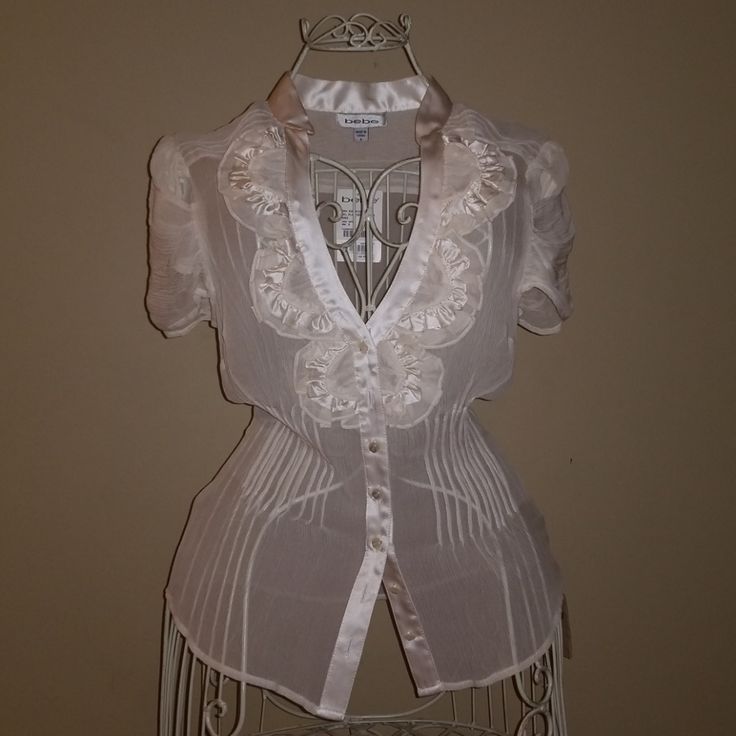 Bebe Sheer Top In White. Nwt! Size Small. Cap Sleeve. Ruffle Neckline Detail. Front Button Up. Feminine Fitted Blouse With Buttons, Fitted Feminine Blouse With Buttons, Feminine Fitted Top With Buttons, Fitted Feminine Top With Buttons, Feminine Fitted Tops With Buttons, Feminine Fitted Buttoned Top, Fitted Cream Top With Buttons, Sheer Top, Sheer Blouse