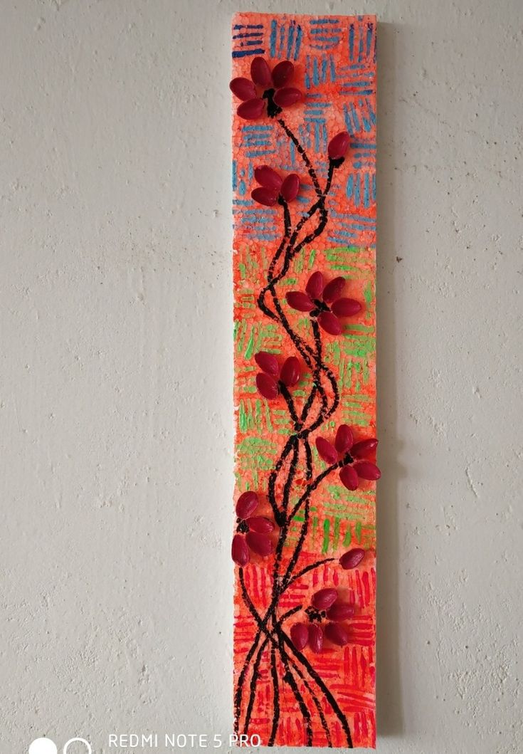 an art piece with flowers painted on it