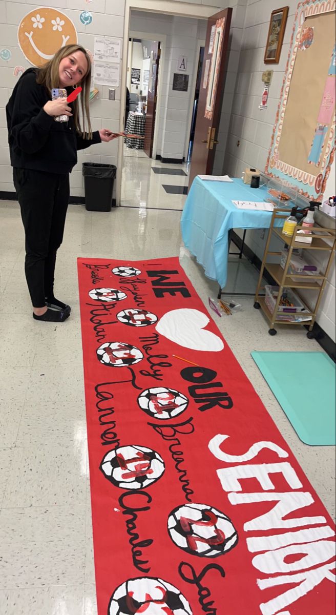 a woman standing in front of a red banner