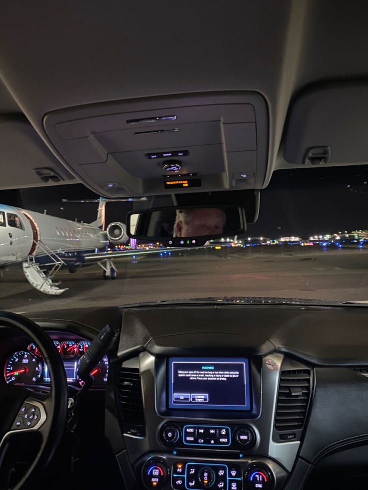 an airplane is sitting on the runway at night