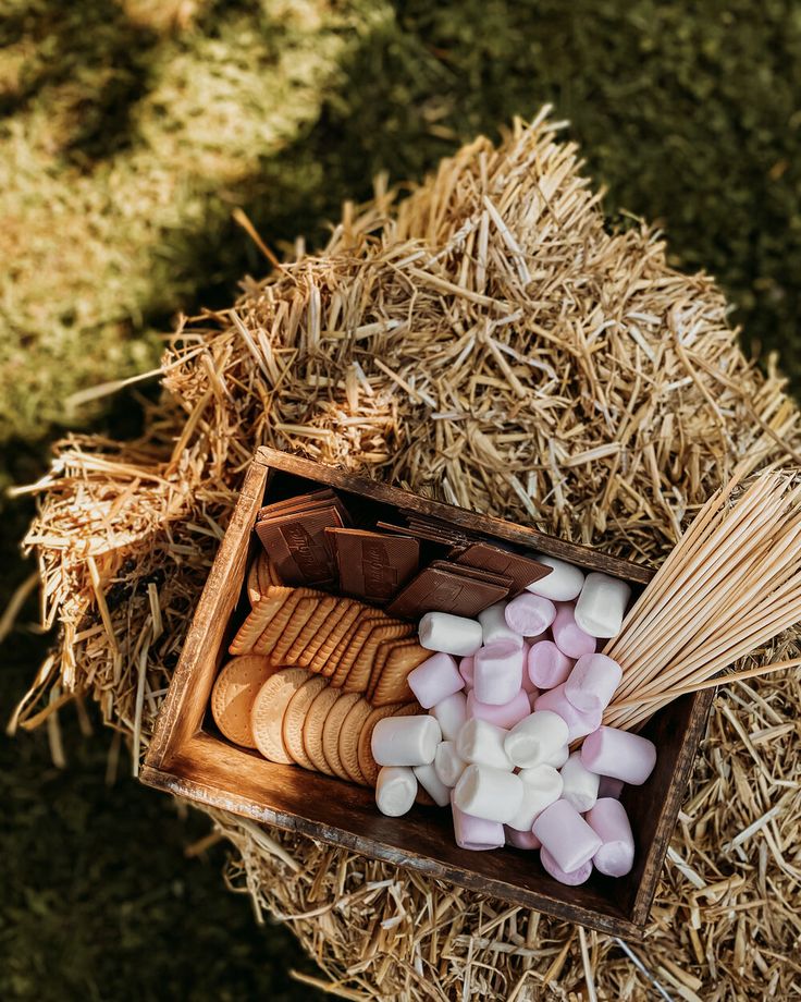 marshmallows and cookies in a wooden box on hay