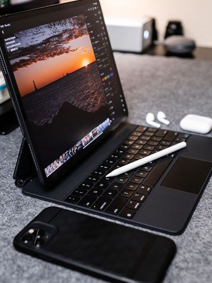 an open laptop computer sitting on top of a table next to a keyboard and mouse