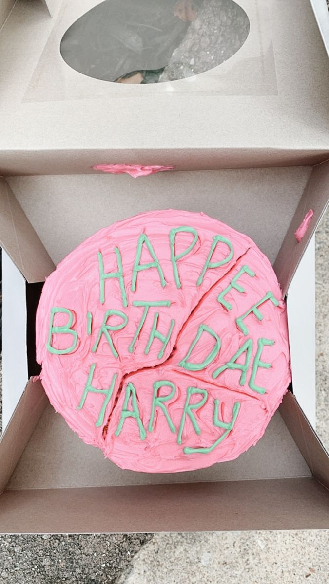 a birthday cake in a box with the words happy birthday harry written on it's side