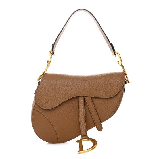 This is an authentic CHRISTIAN DIOR Grained Calfskin Saddle Bag in Camello. This saddle-shaped handbag is crafted of grained calfskin leather in brown and features a matching leather strap, secured with aged gold CD logo anchors. The front flap has an aged gold D initial logo and opens to a brown suede interior with a zipper pocket. Dior Saddle Brown, Essential Handbags, D Initial, Yves Klein Blue, Christian Dior Bag, Initial Logo, Dior Saddle, Leather Saddle Bags, Saddle Brown