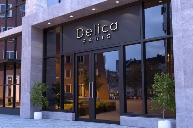 the entrance to delica paris is lit up at night, with plants in front