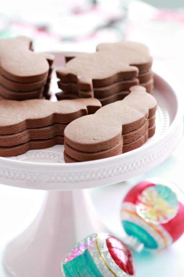 some cookies are on a white cake plate