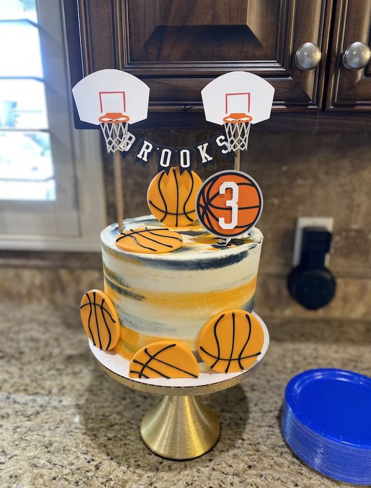 a three tiered cake with basketballs on it