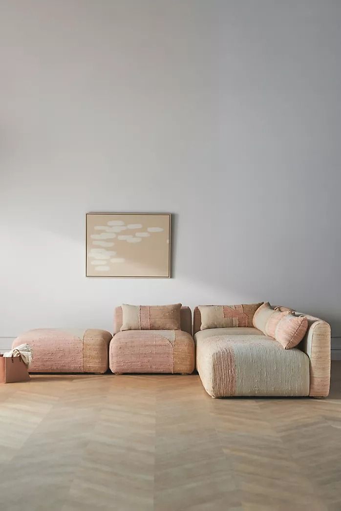 a living room with two couches and a painting on the wall above it,