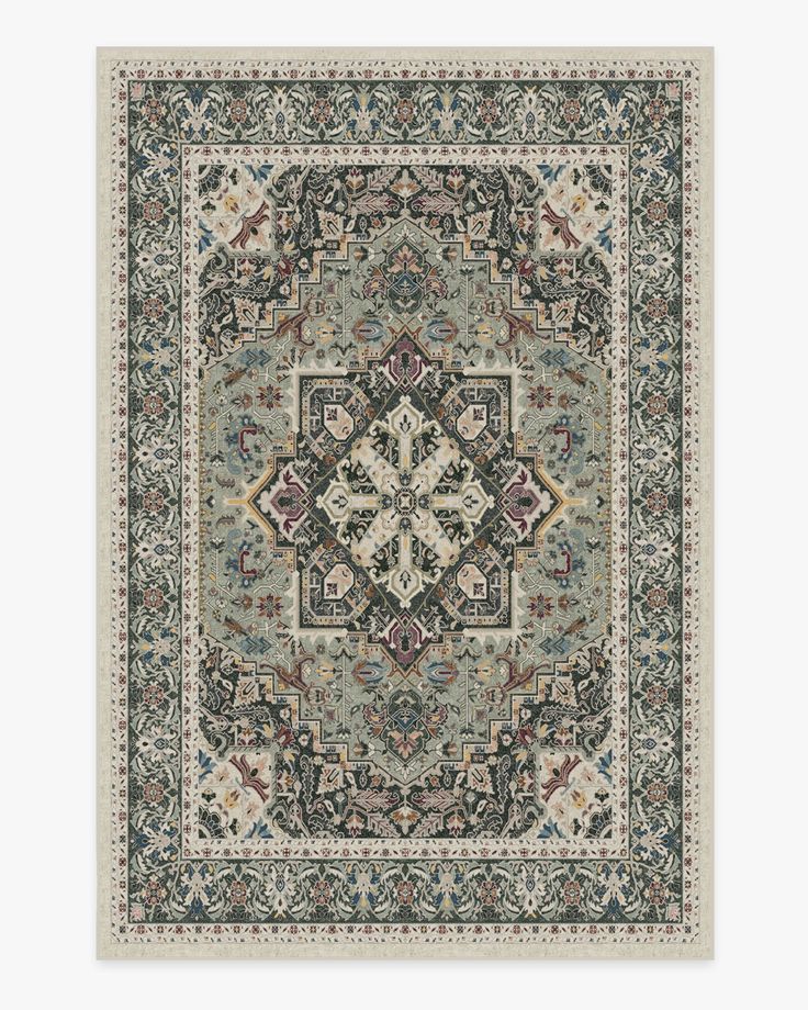 a rug with an ornate design on the front and back side, in grey tones